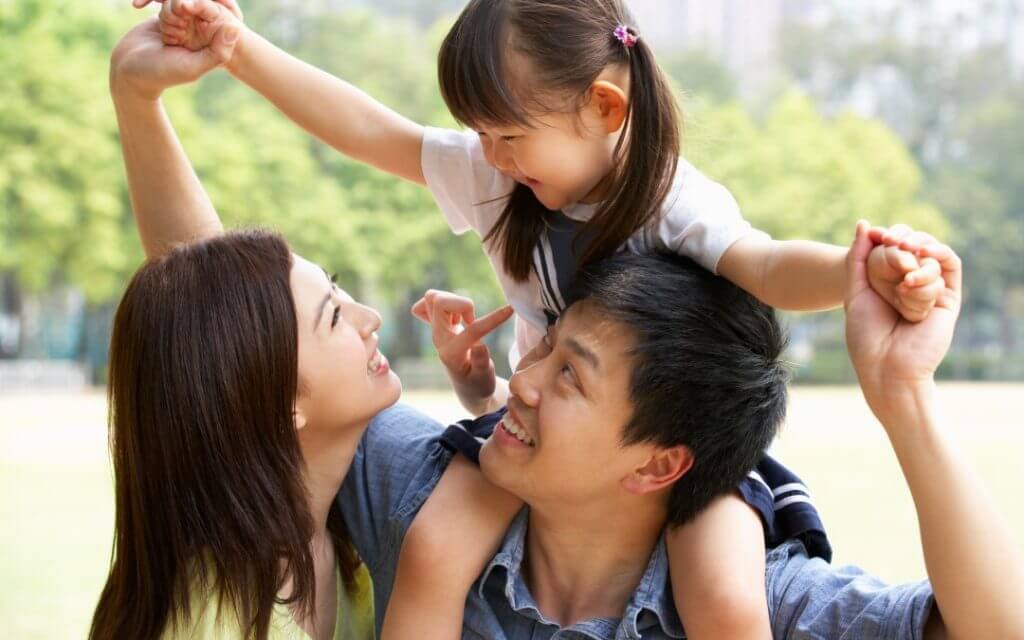 Family posing and having fun at a park